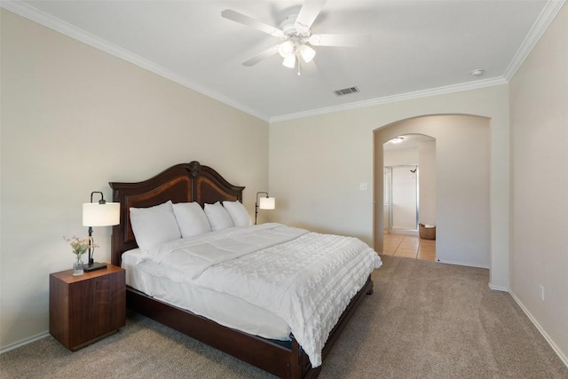 bedroom with arched walkways, light colored carpet, visible vents, ornamental molding, and baseboards