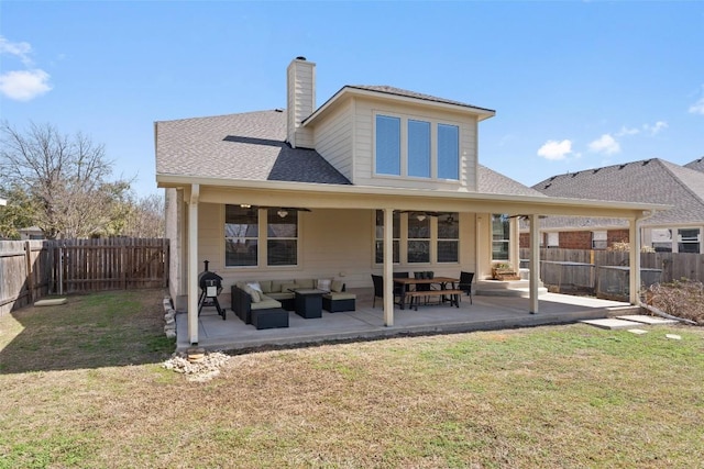 rear view of property featuring a patio area, a yard, outdoor lounge area, and a fenced backyard