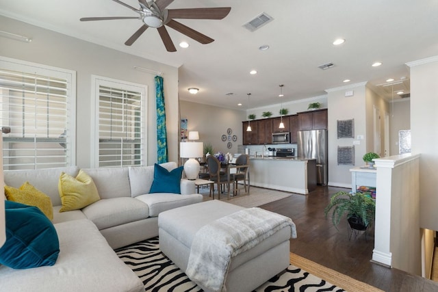 living area featuring dark wood-style floors, attic access, visible vents, and recessed lighting