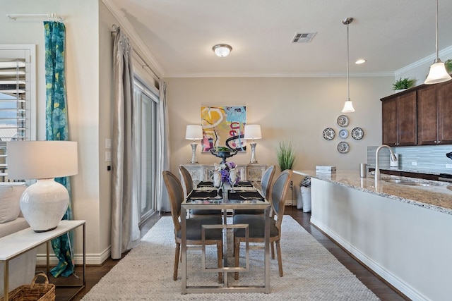1209 Highknoll Ln, Georgetown, TX 78628 - dining area with crown molding, dark wood finished floors, and baseboards