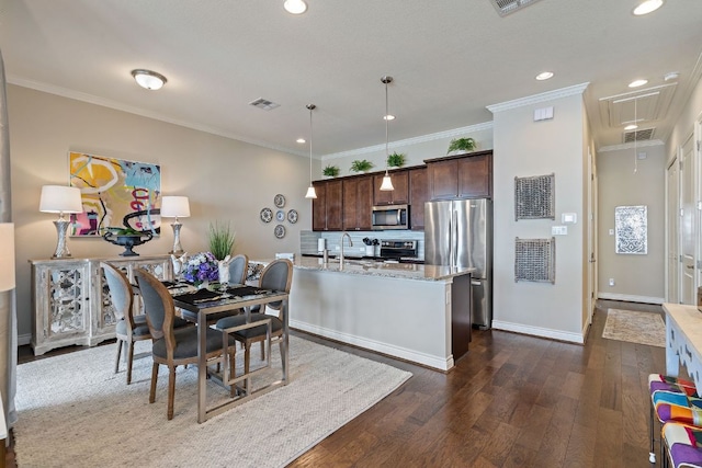 1209 Highknoll Ln, Georgetown, TX 78628 - dining space featuring attic access, dark wood finished floors, recessed lighting, crown molding, and baseboards