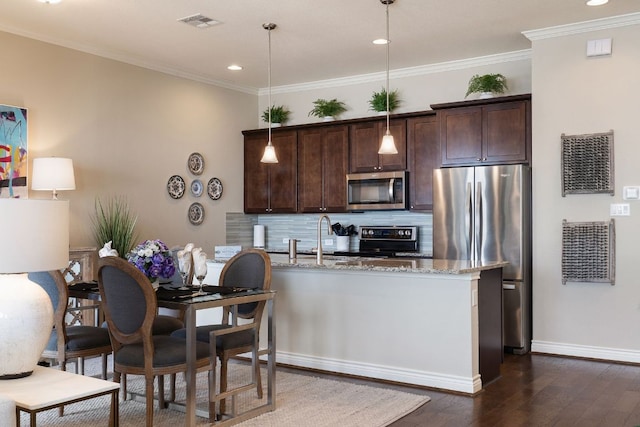 kitchen featuring dark brown cabinets, appliances with stainless steel finishes, tasteful backsplash, dark wood finished floors, and crown molding