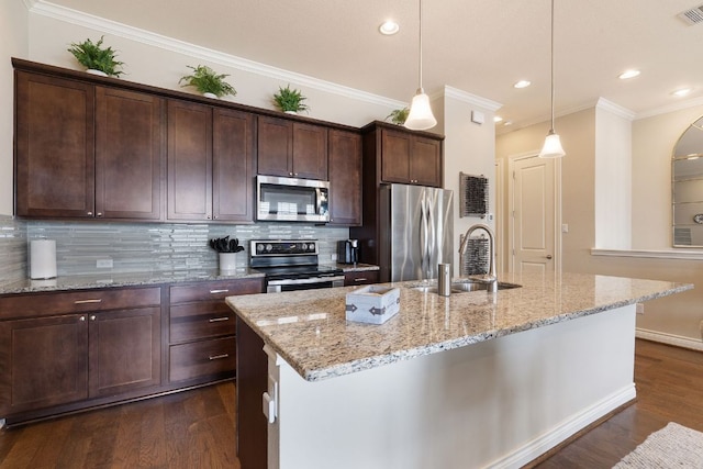 kitchen with tasteful backsplash, appliances with stainless steel finishes, dark wood-style flooring, dark brown cabinets, and a sink