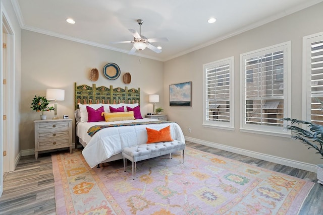 bedroom with ornamental molding, recessed lighting, baseboards, and wood finished floors