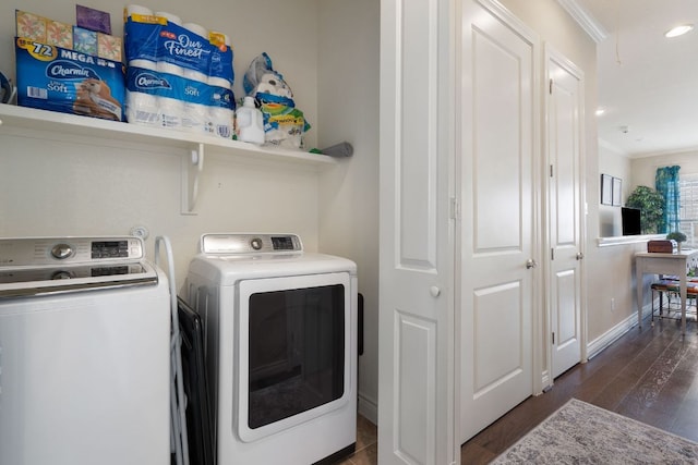 laundry room with laundry area, washing machine and dryer, and wood finished floors