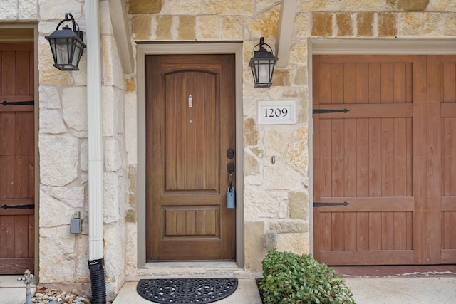 entrance to property featuring stone siding