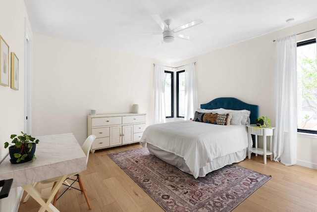 bedroom featuring light wood finished floors and a ceiling fan