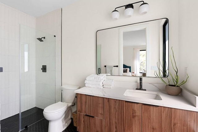 full bathroom with a shower stall, toilet, and vanity