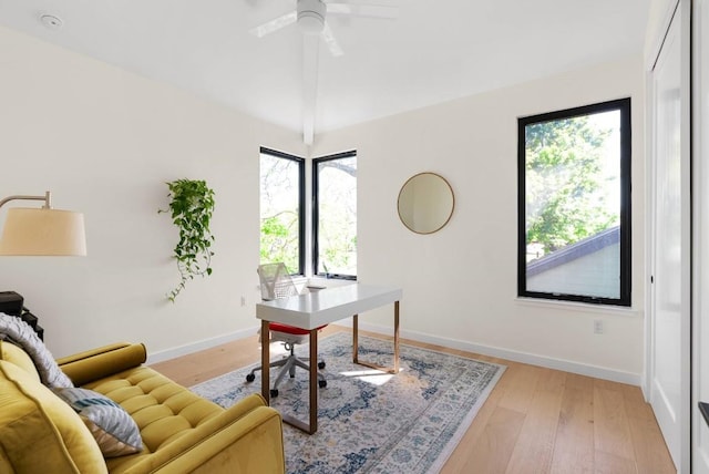 office area with ceiling fan, light wood finished floors, lofted ceiling, and baseboards