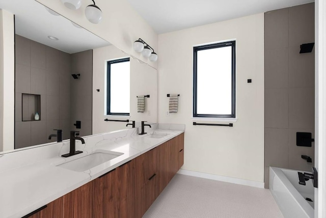 bathroom featuring a shower, plenty of natural light, and a sink