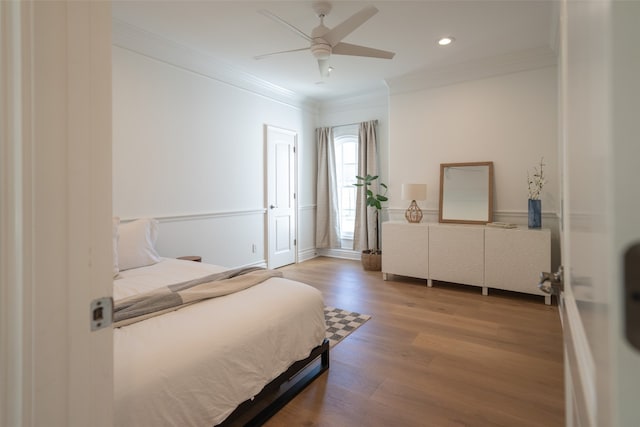 bedroom with ornamental molding, recessed lighting, a ceiling fan, and wood finished floors