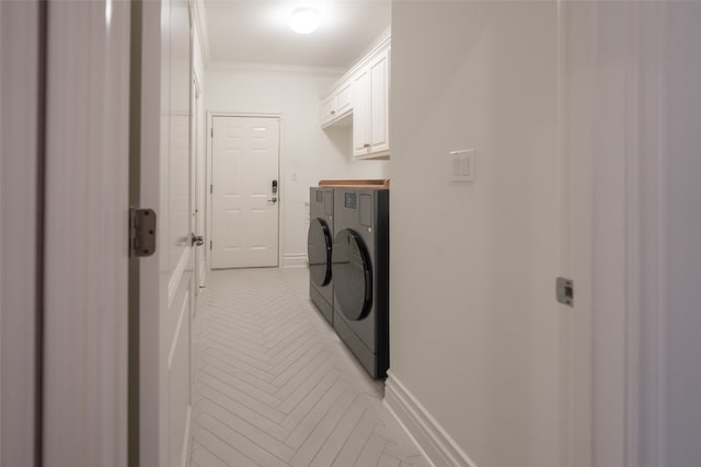 laundry room featuring cabinet space, baseboards, ornamental molding, and washer and dryer