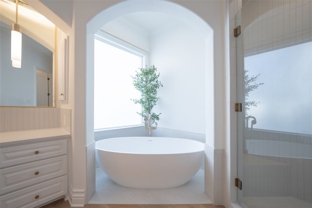 2301 Manana St, Austin, TX 78730 - full bathroom with vanity, a freestanding bath, a wainscoted wall, and a stall shower