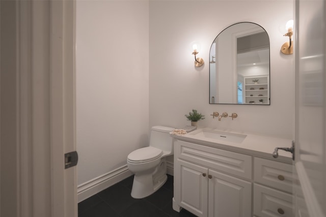 half bath with vanity, tile patterned flooring, toilet, and baseboards