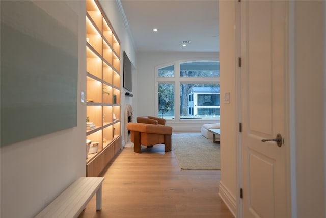 hall with light wood finished floors and recessed lighting