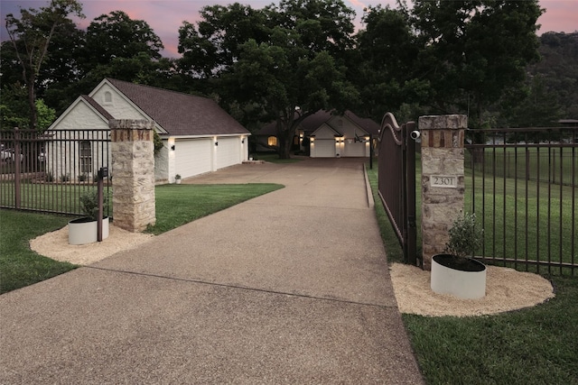 exterior space featuring a yard, an outdoor structure, fence, and a gate