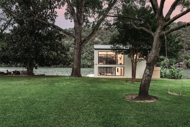 yard at dusk with a water view