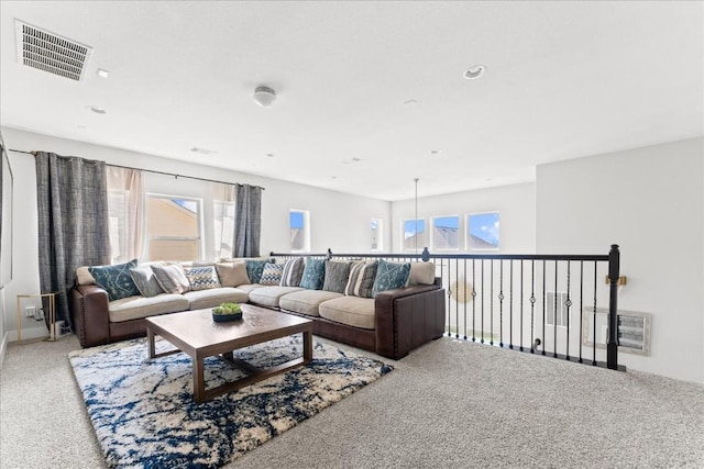 carpeted living area featuring visible vents