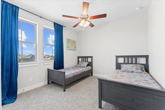 bedroom featuring carpet floors, baseboards, and a ceiling fan