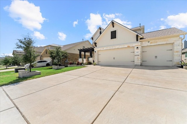 view of front of house featuring a garage, stone siding, driveway, stucco siding, and a front lawn