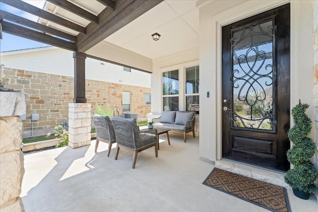 view of exterior entry with an outdoor living space