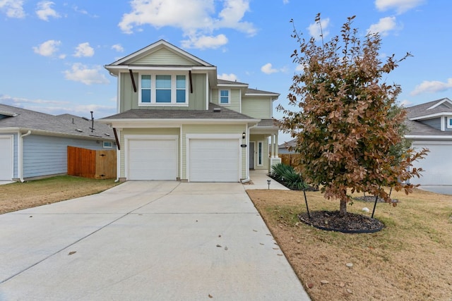 view of front of house featuring an attached garage, fence, a front lawn, and concrete driveway