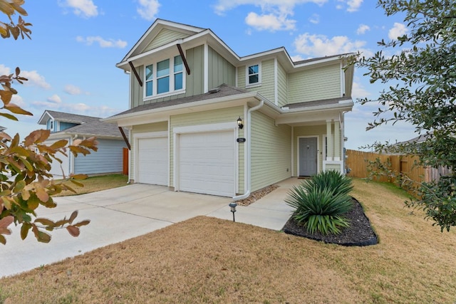 view of front of house featuring an attached garage, fence, concrete driveway, a front lawn, and board and batten siding