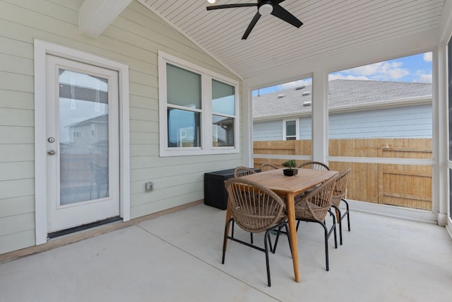 sunroom / solarium featuring vaulted ceiling, ceiling fan, and wooden ceiling