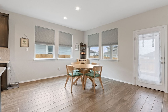 dining space featuring light wood-style flooring, baseboards, and recessed lighting