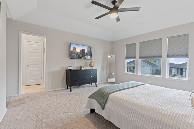 bedroom featuring lofted ceiling, ceiling fan, baseboards, and light colored carpet