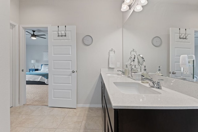 bathroom with ceiling fan, double vanity, a sink, and connected bathroom