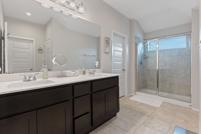 bathroom with double vanity, a sink, and a shower stall