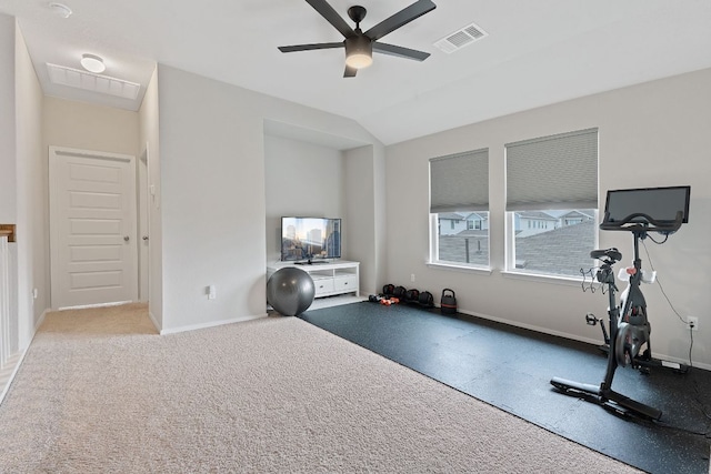 exercise area featuring lofted ceiling, baseboards, visible vents, and a ceiling fan