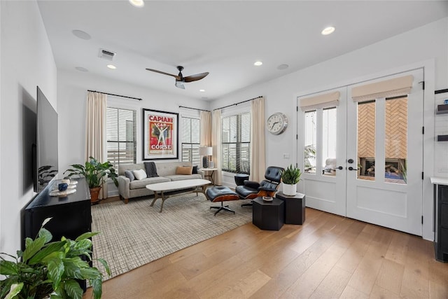 sitting room with recessed lighting, light wood-style floors, plenty of natural light, and french doors