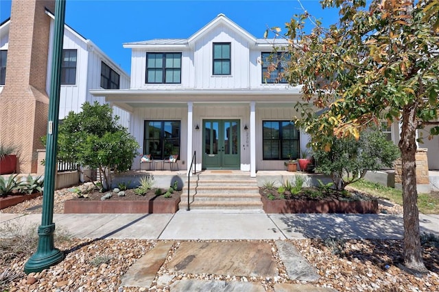 modern farmhouse style home with board and batten siding, french doors, and covered porch