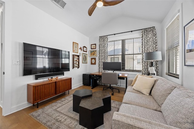 living room featuring baseboards, visible vents, ceiling fan, wood finished floors, and vaulted ceiling