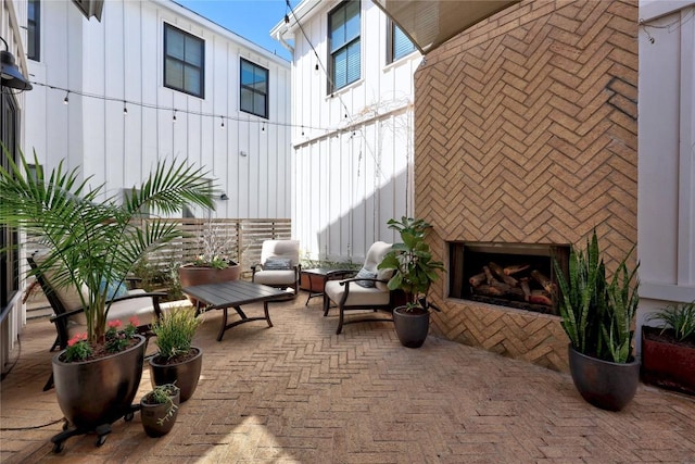 view of patio / terrace featuring exterior fireplace