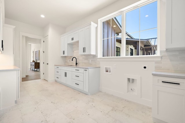 interior space featuring recessed lighting, hookup for an electric dryer, cabinet space, and baseboards