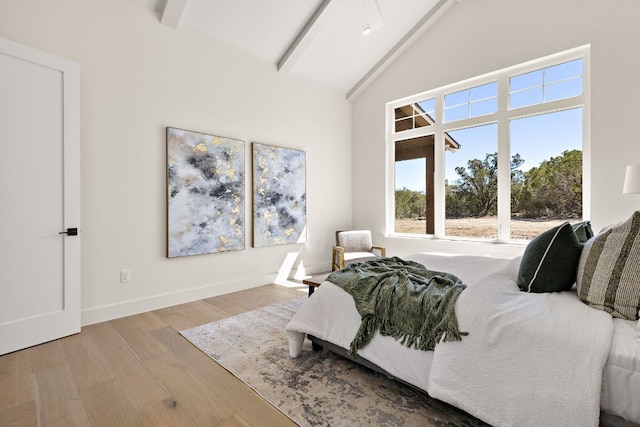 bedroom with baseboards, high vaulted ceiling, wood finished floors, and beamed ceiling