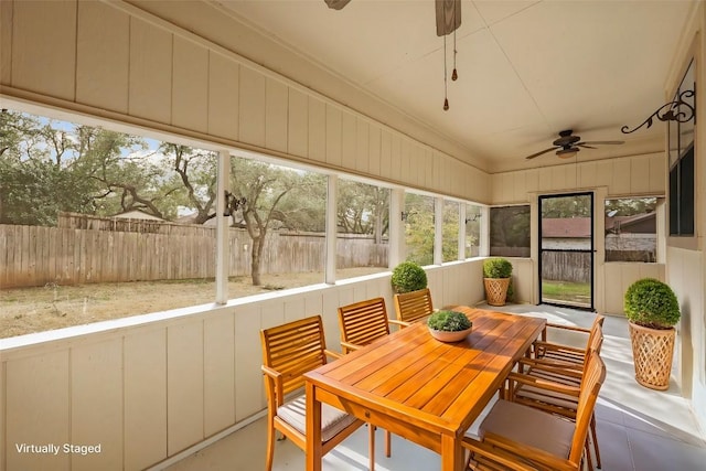 sunroom / solarium with a ceiling fan