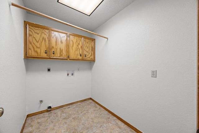 laundry room featuring gas dryer hookup, washer hookup, baseboards, cabinet space, and electric dryer hookup