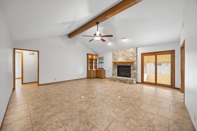 unfurnished living room featuring vaulted ceiling with beams, ceiling fan, a stone fireplace, a textured ceiling, and baseboards