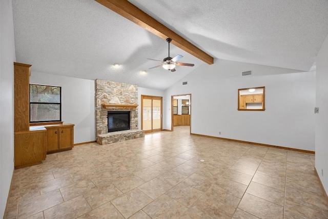 unfurnished living room featuring lofted ceiling with beams, a textured ceiling, a stone fireplace, visible vents, and a ceiling fan