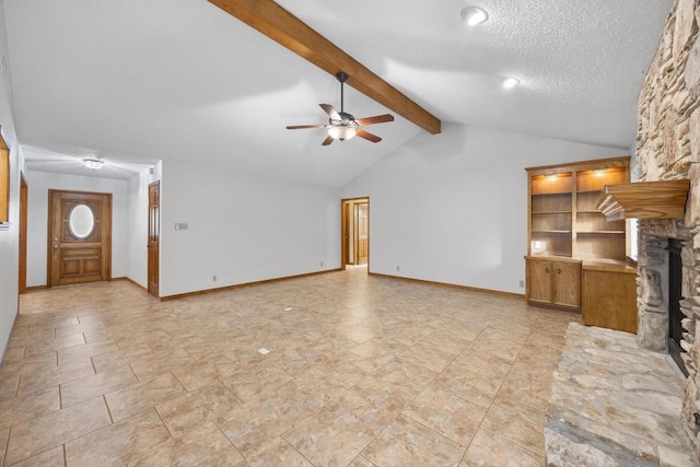 unfurnished living room featuring vaulted ceiling with beams, ceiling fan, a textured ceiling, a fireplace, and baseboards