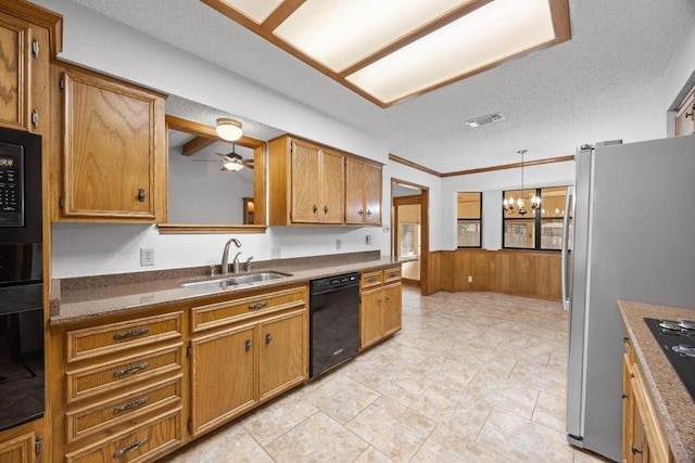 kitchen with brown cabinets, visible vents, a sink, and black appliances