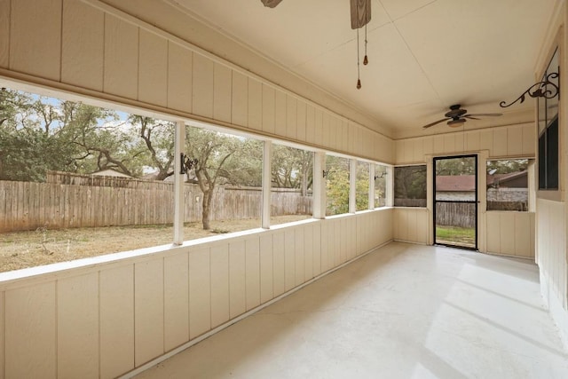 unfurnished sunroom with ceiling fan