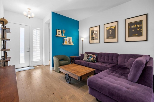 living area with wood finished floors and a notable chandelier