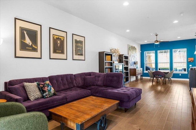 living room with baseboards, ceiling fan, wood finished floors, and recessed lighting