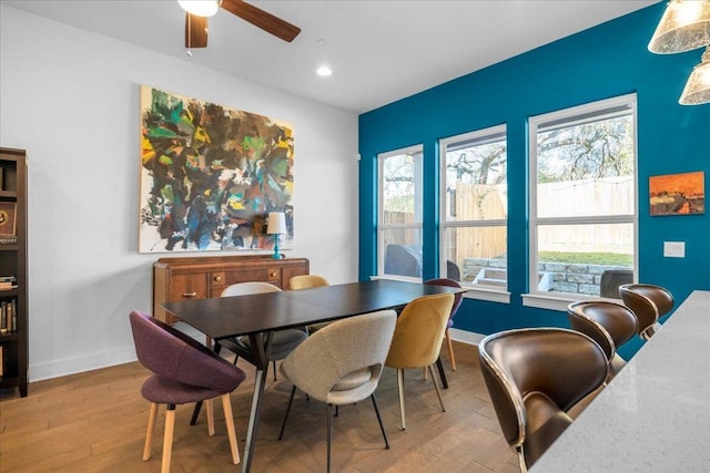 dining space with ceiling fan, baseboards, wood finished floors, and recessed lighting