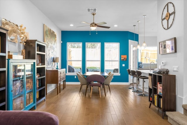 dining area featuring a ceiling fan, recessed lighting, visible vents, and wood finished floors